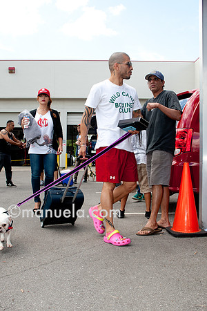 Miguel Cotto arrives at the Don Miguel Boxing Gym in Orlando with one of his French bulldogs and wife Melissa in backround