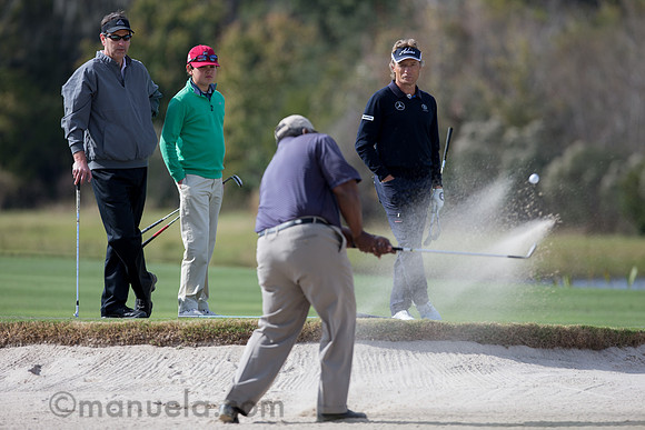 Bernhard Langer watches Amateur's bunker shot